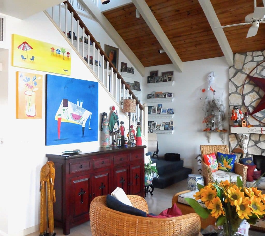 A beach-house piece and a blue table-scene collage in a two-storey living room
