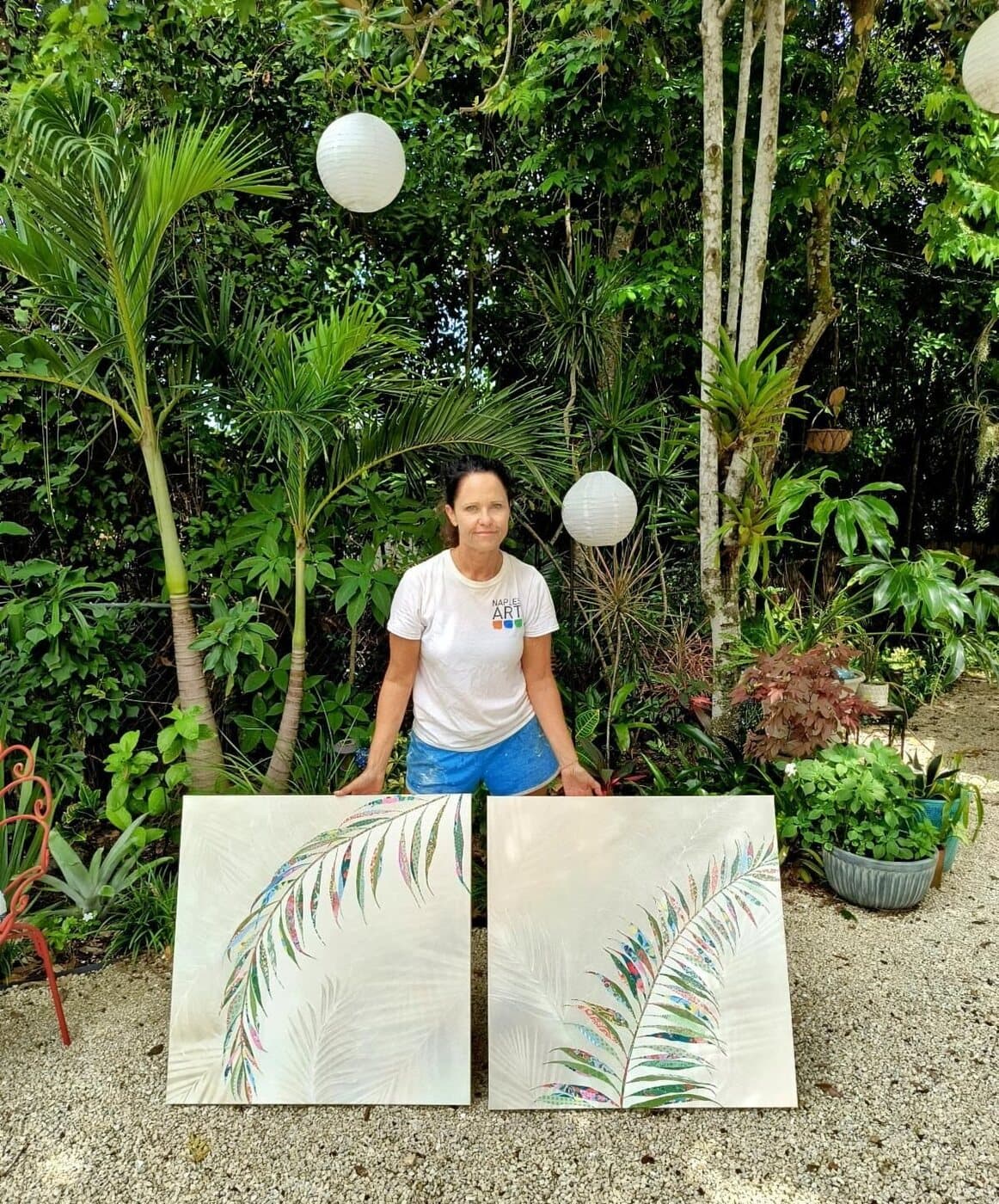 Jennifer in the garden with a pair of palm frond panels