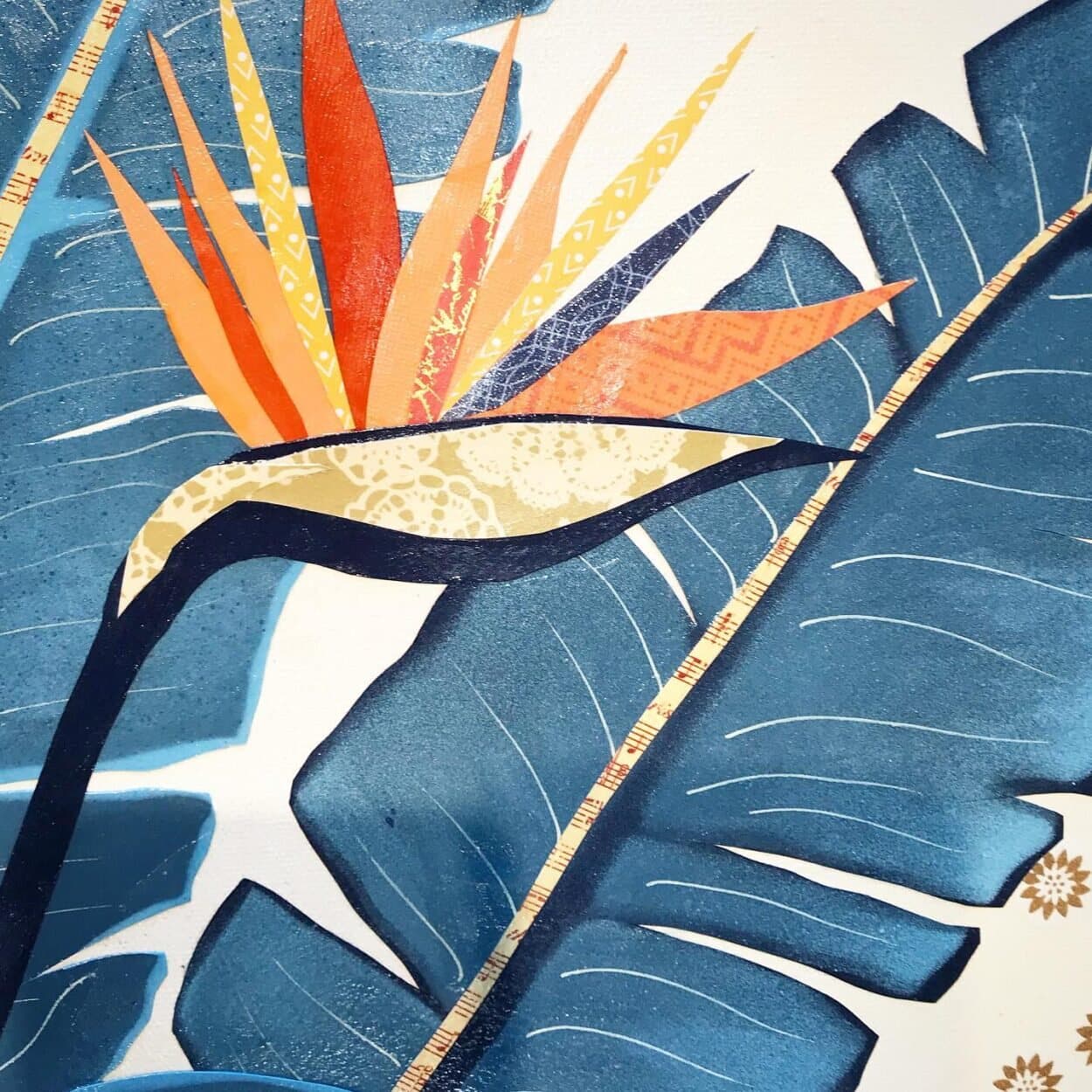 Close-up of a finished bird of paradise collage — cut paper edges casting real shadows