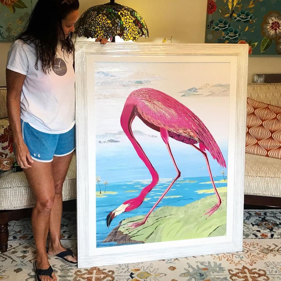 A collector at home with a large framed flamingo piece