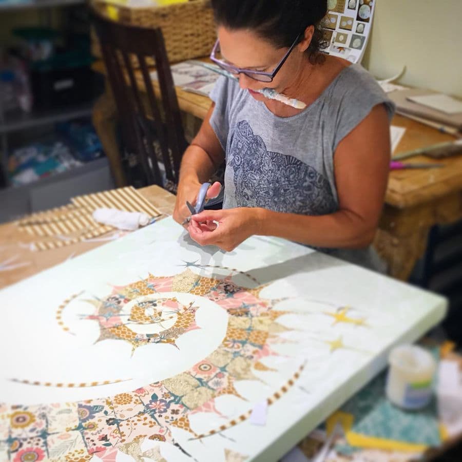 Jennifer cutting a mandala at the worktable