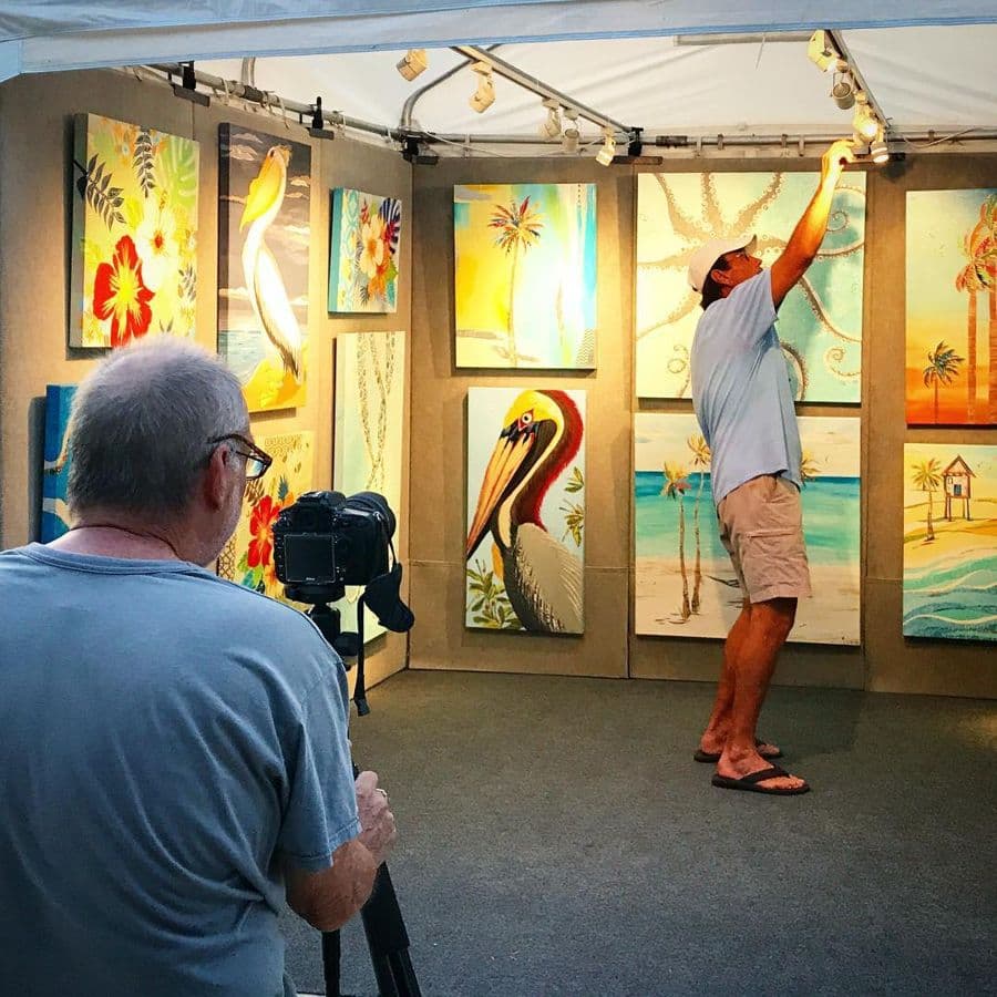 Steve hanging pieces in the booth at first light